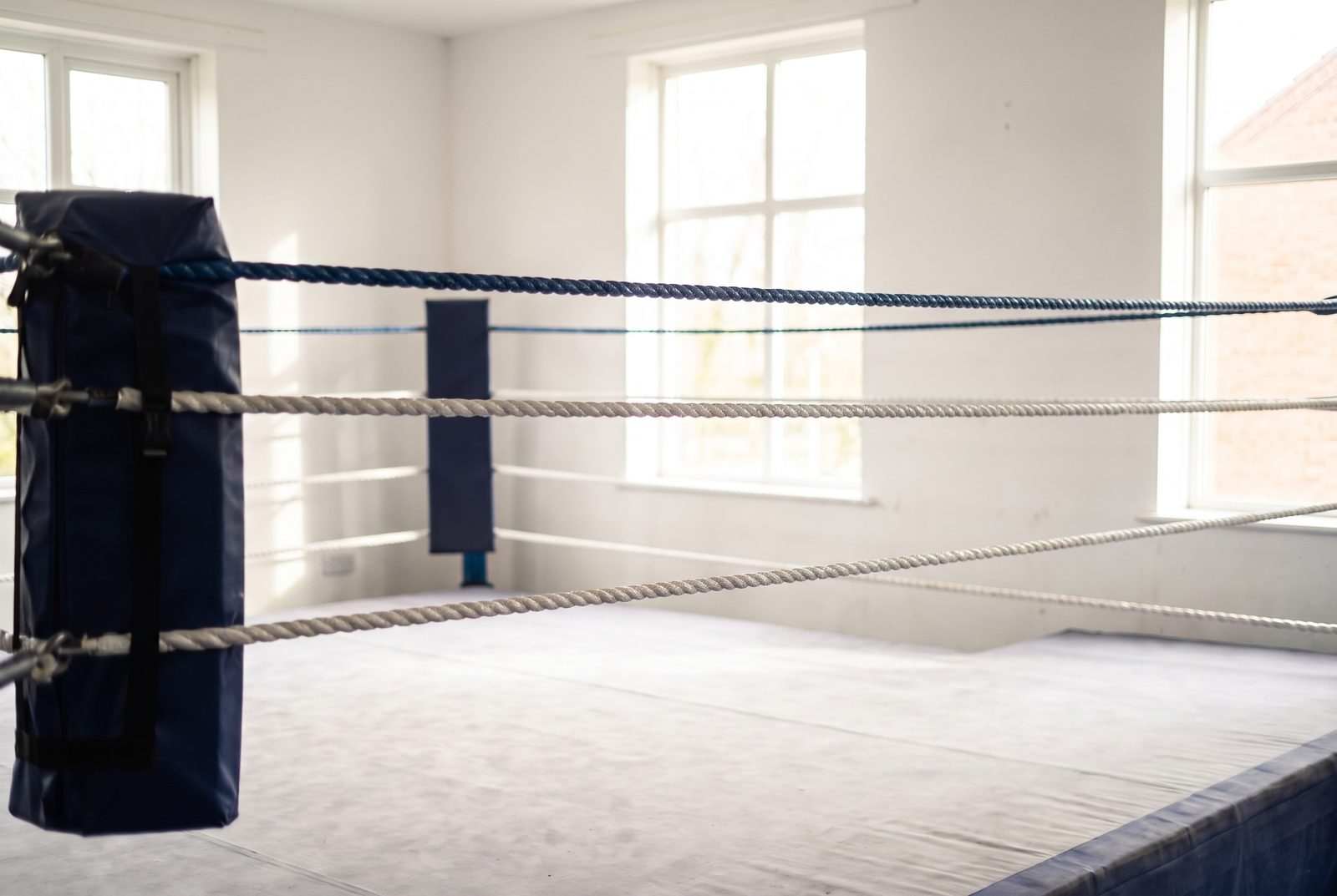 The empty ring in daylight, corner post and ropes in focus